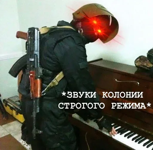 Человек в полной боевой экипировке стоит в позе пианиста и нажимает на клавиши инструмента. — человек в тактическом шлеме и бронежилете