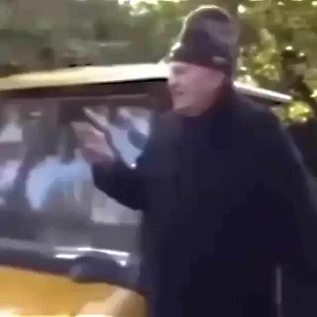 Мужчина указывает пальцем в сторону, поправляет шапку или жестикулирует рукой с сигаретой, высказывая недовольство.